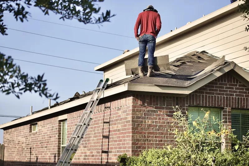 Professional roofer working on a residential roof in Enid